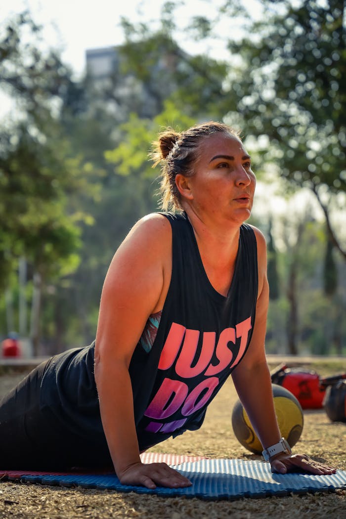gallery-5 Woman practicing yoga on mat in sunny Puebla park, promoting fitness and healthy lifestyle.
